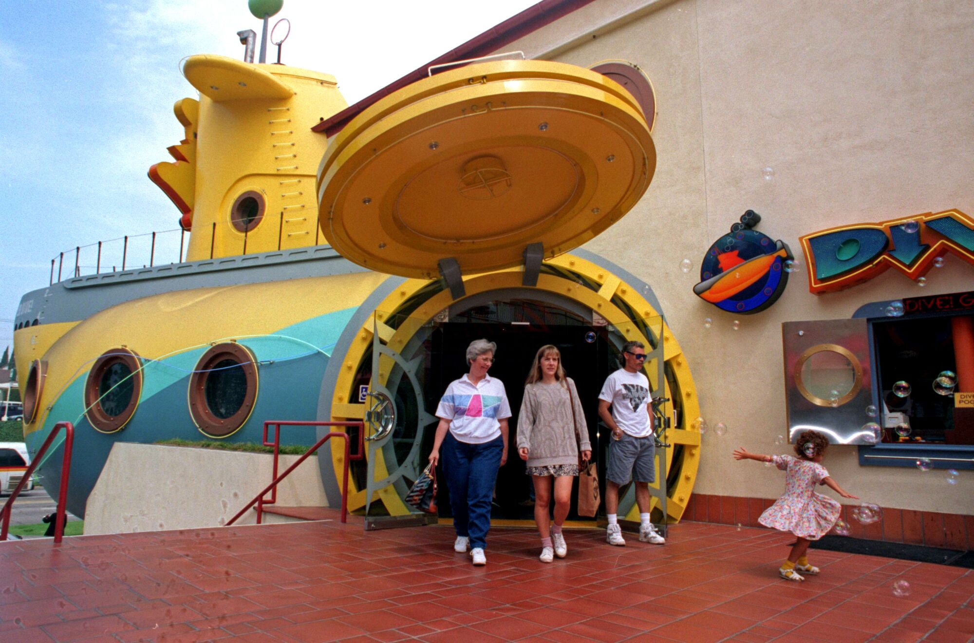 People walk out of a giant fake submarine 