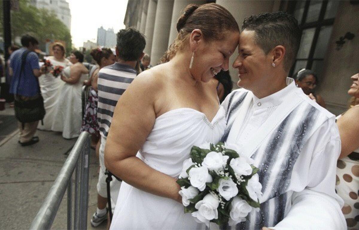 In New York, Maira Garcia, right, and Maria Vargas wait in line to get married at the Brooklyn City Clerk¿s office last year.