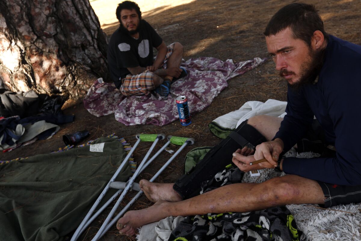 Jason McKenney, right, said he has spent some nights in a park near the 170 Freeway in North Hollywood.