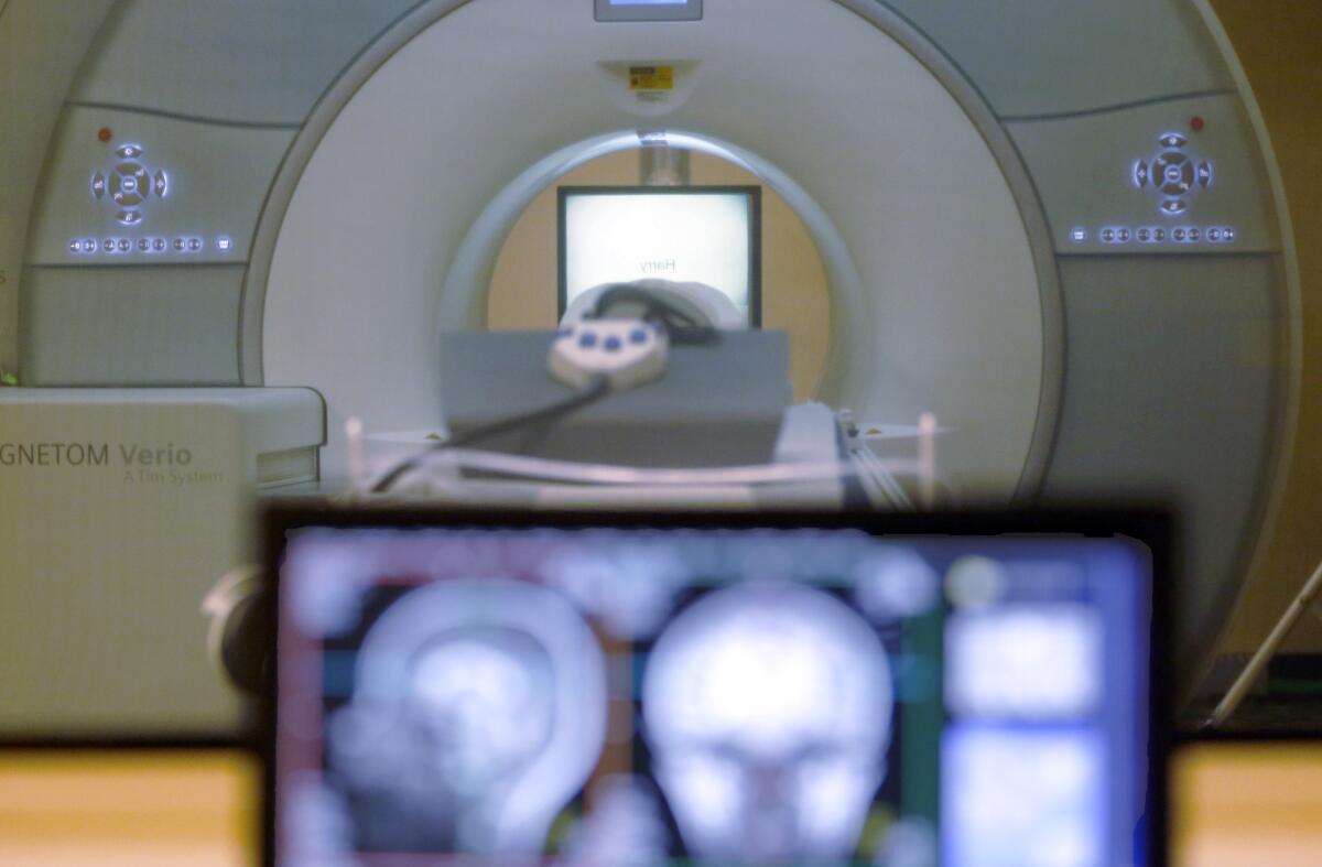 A patient enters the circular tube of an MRI machine