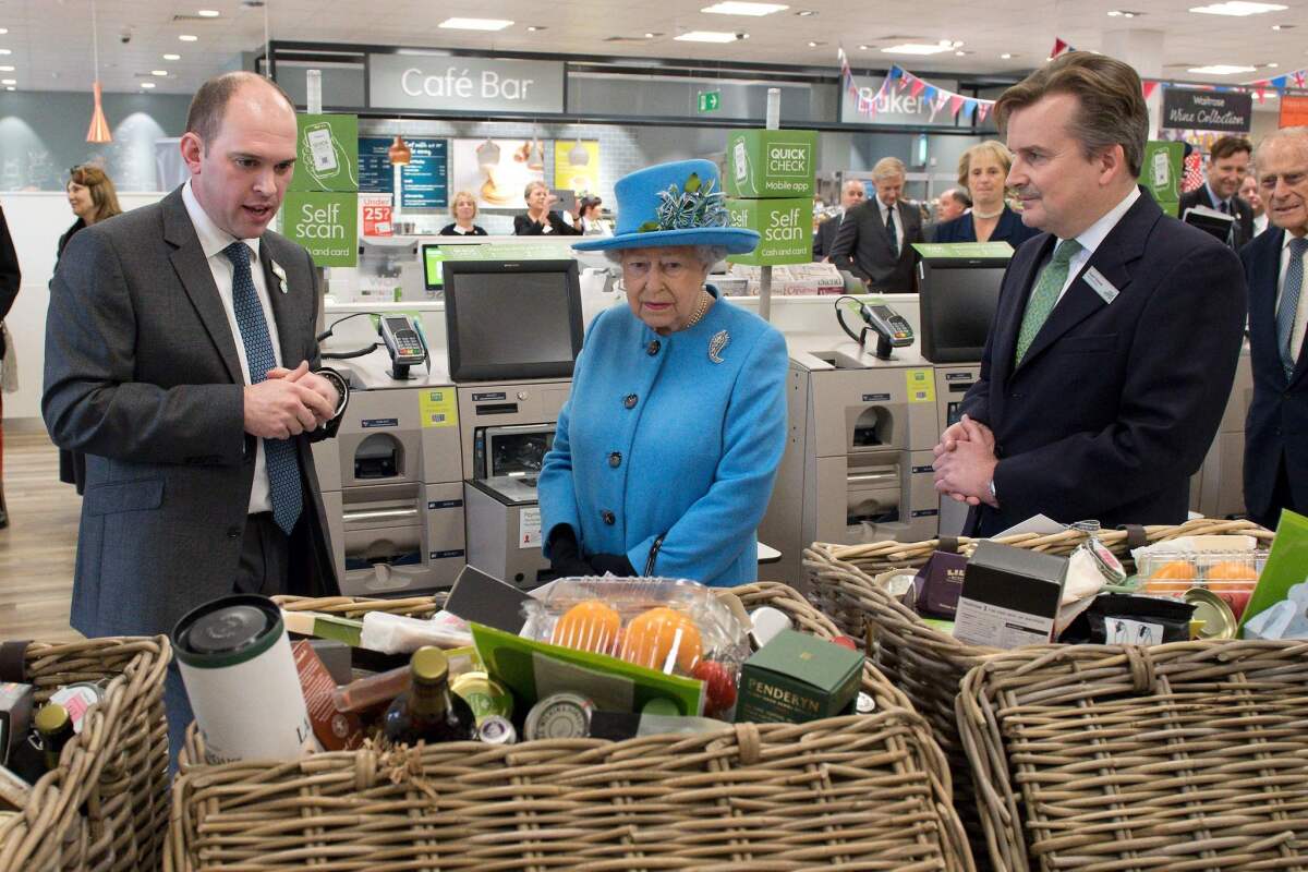 Queen Elizabeth II scopes out the goods near the checkout.