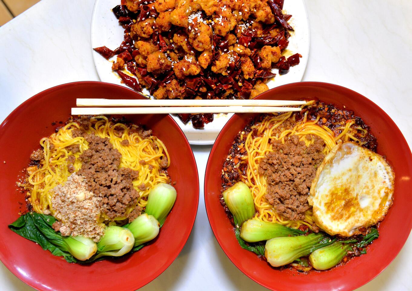 Some of the dishes available at Chong Qing Special Noodles in San Gabriel are fried chicken with chilies, top, dandan mian noodles, left, and Chongqing noodles, right.