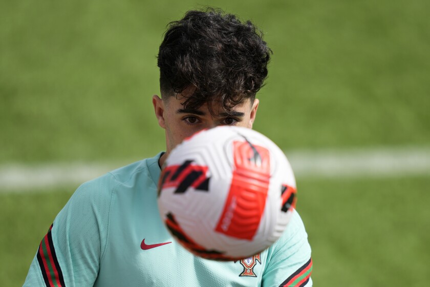 Portugal's Vitinha eyes a ball during a training session of the Portuguese soccer team in Oeiras, outside Lisbon, Wednesday, June 8, 2022. Portugal will face the Czech Republic June 9 in a Nations League match in Lisbon. (AP Photo/Armando Franca)