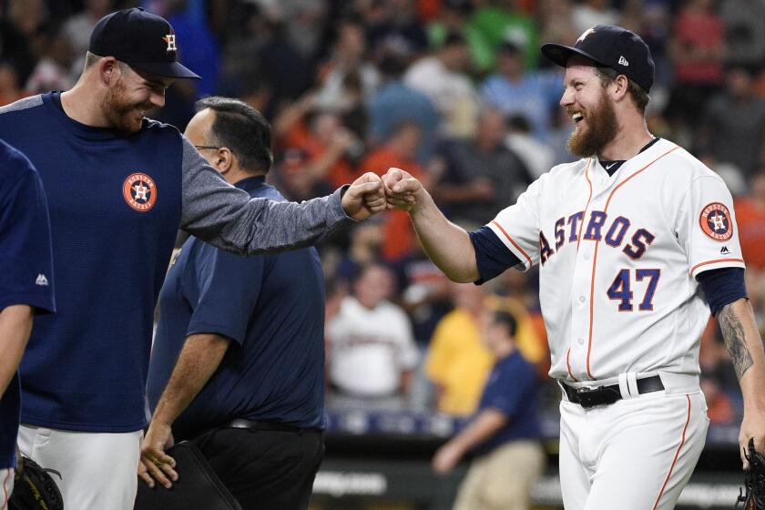 Houston Astros relief pitcher Chris Devenski, right, celebrates with Joe Biagini, who had pitched the eighth inning, the team's win and four-pitcher combined no-hitter in a 9-0 win over the Seattle Mariners in a baseball game, Saturday, Aug. 3, 2019, in Houston. (AP Photo/Eric Christian Smith)