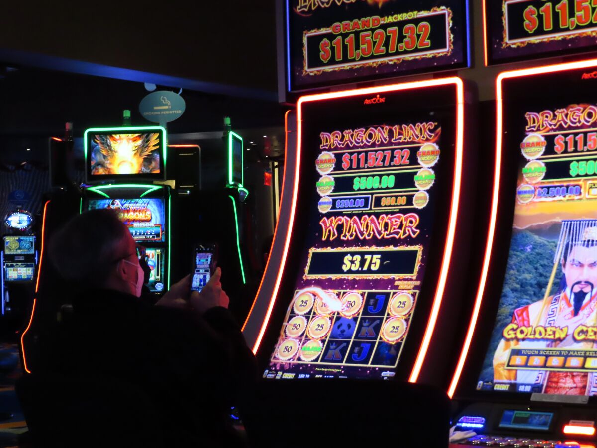 A customer playing a slot machine at the Ocean Casino Resort on Feb. 10, 2022 in Atlantic City N.J. On Tuesday, Feb. 15, the American Gaming Association released figures showing that U.S. commercial casinos won $53 billion in 2021, making it the gambling industry's best year ever. (AP Photo/Wayne Parry)