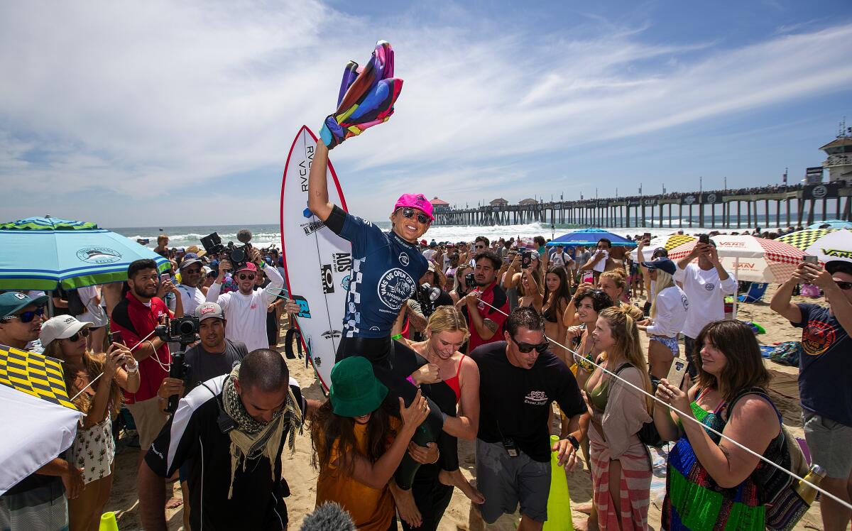 Fans as Sage Erickson is carried after winning the U.S. Open of Surfing women’s championship finals in 2019.