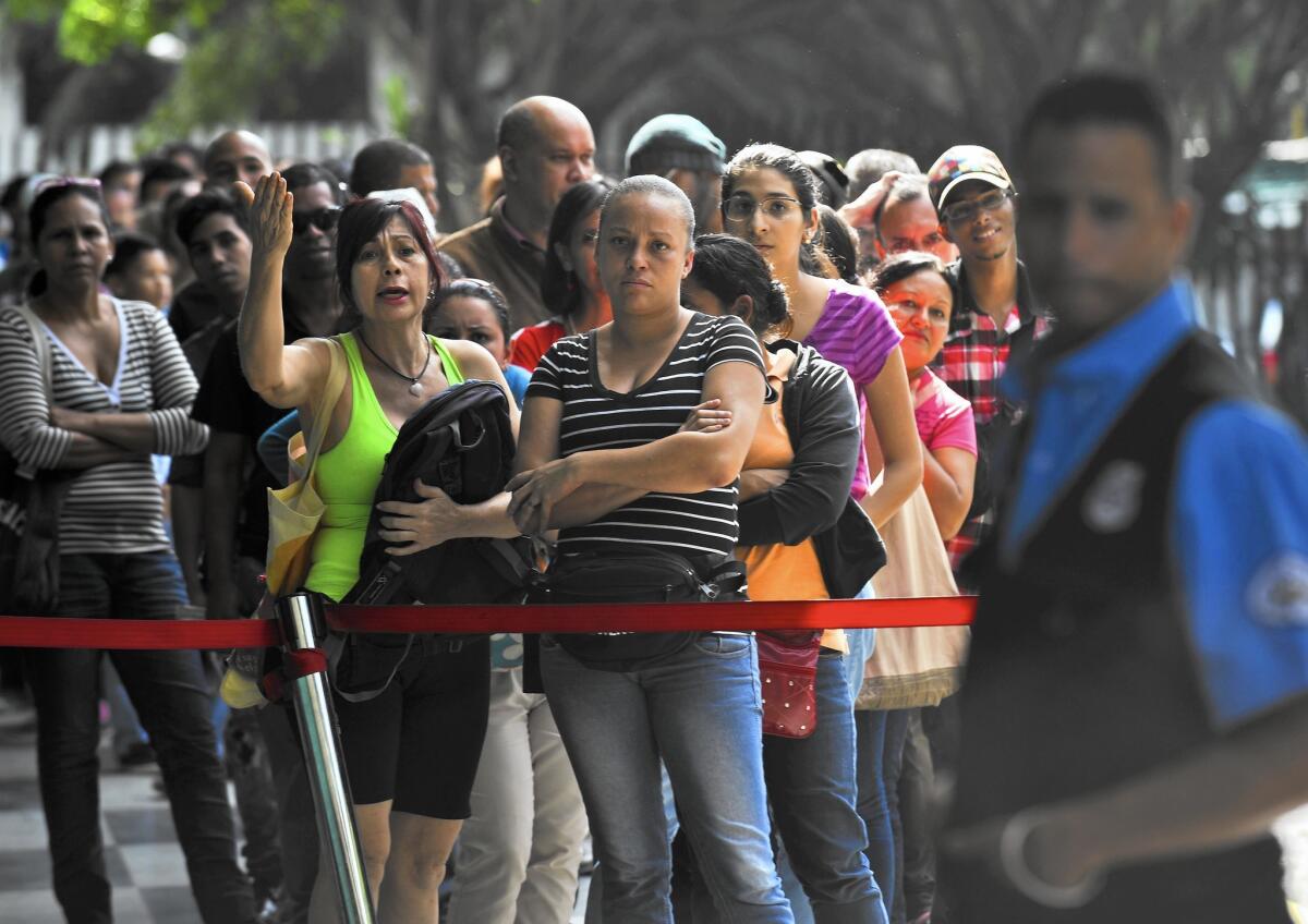 People in Caracas, Venezuela, wait to buy food on Dec. 4, 2015.