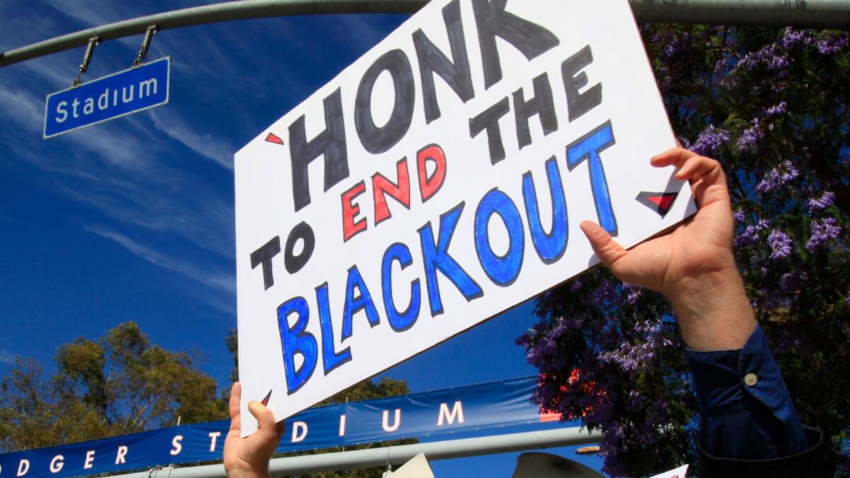 Bill Peterson of Los Angeles protests the Dodgers Channel blackout outside Dodger Stadium in June 2014.