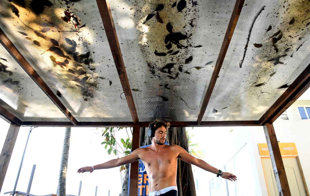 Surfer Bryan Perez stretches before competing