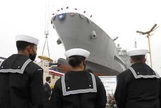 Sailors stand pierside near the The USNS Harvey Milk set to be christened at General Dynamics NASSCO.