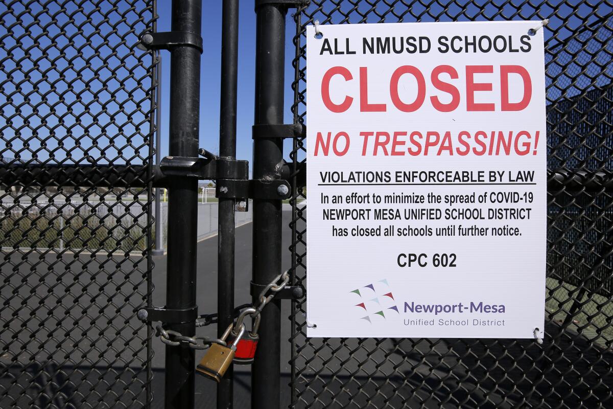 A July 2020 sign at Newport Harbor High School states that all district schools are closed.