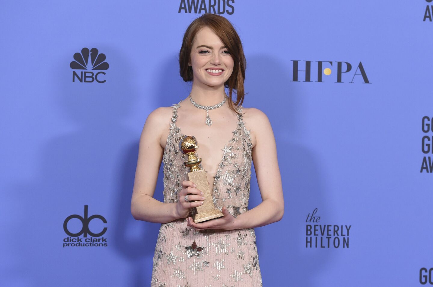 Emma Stone with her award for actress in a motion picture musical or comedy for "La La Land."