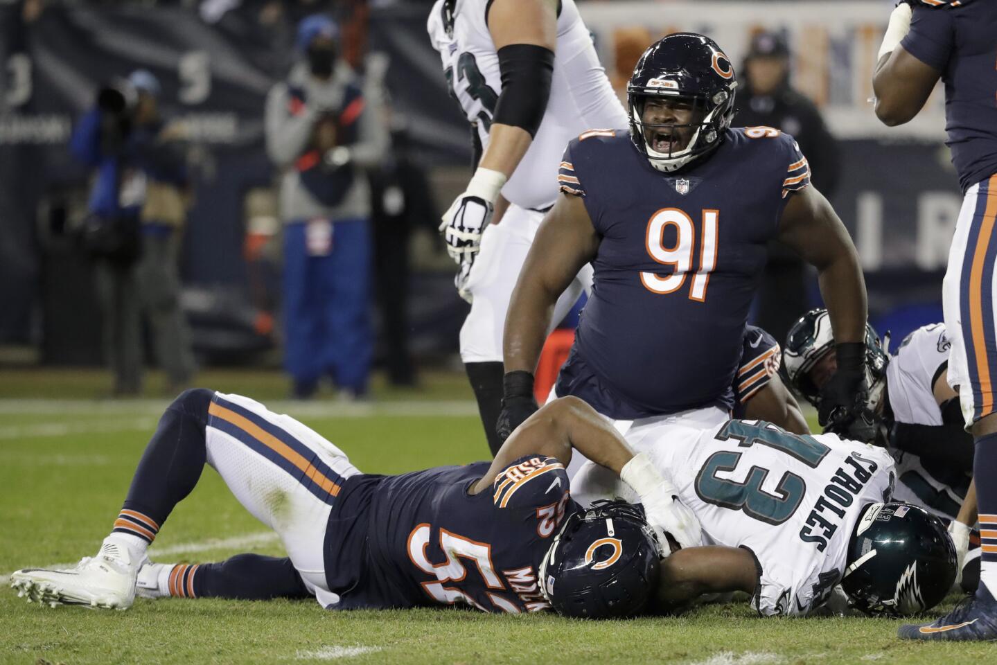 Chicago Bears nose tackle Eddie Goldman (91) reacts as Chicago Bears linebacker Khalil Mack (52) stops Philadelphia Eagles running back Darren Sproles (43) during the second half of an NFL wild-card playoff football game Sunday, Jan. 6, 2019, in Chicago.