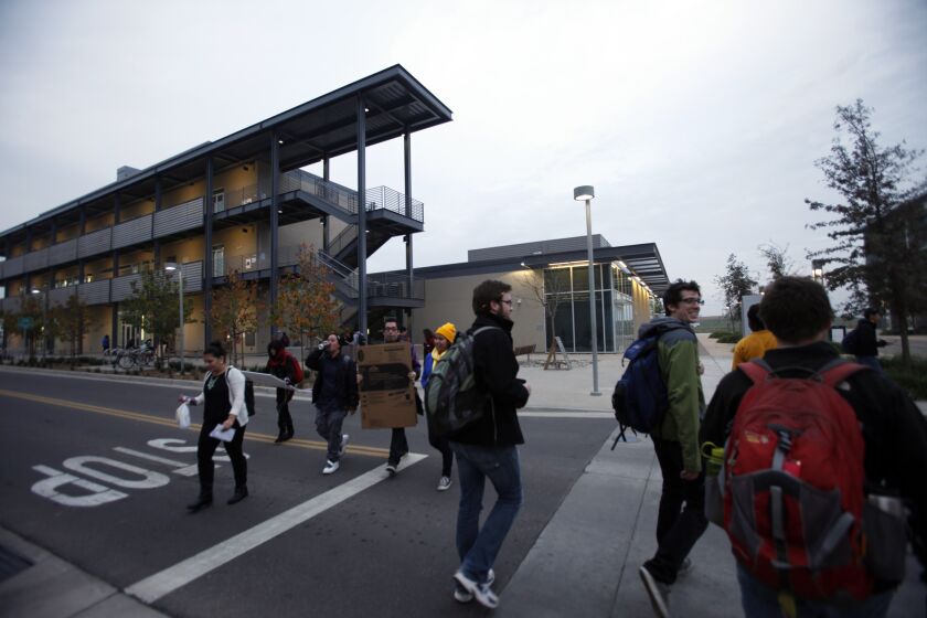 Students make their way toward the Student Services Building on the UC Merced campus in December 2014.