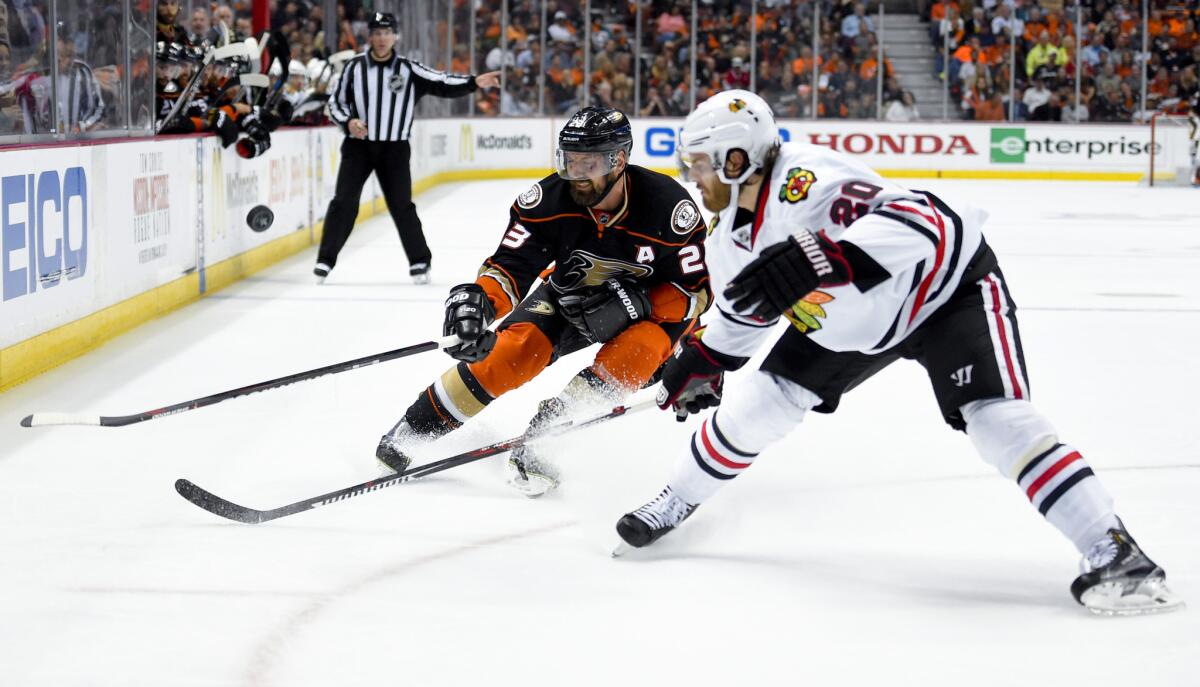 Ducks defenseman Francois Beauchemin knocks the puck away from Blackhawks forward Brandon Saad during the secon period of Game 2 of the Western Conference finals.