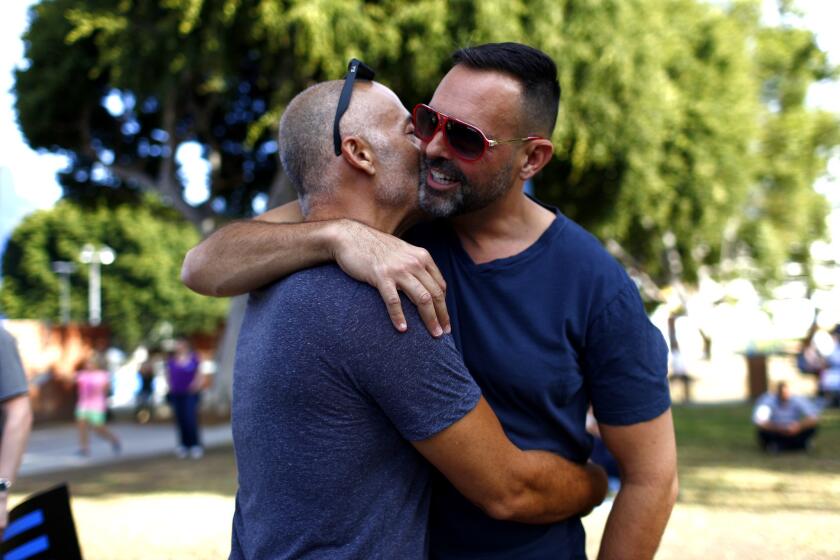 Michael Hauser and Jack Tarantino embrace before the start of a celebration rally at West Hollywood Park on June 26, after a landmark Supreme Court decision that same-sex couples have a constitutional right to marriage that cannot be denied by state law.