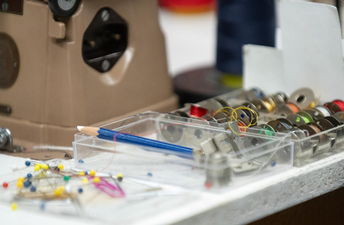 Bobbins of thread in a variety of colors sit on the workbench of Barbara "Corki" Rawlings in Newport Beach.