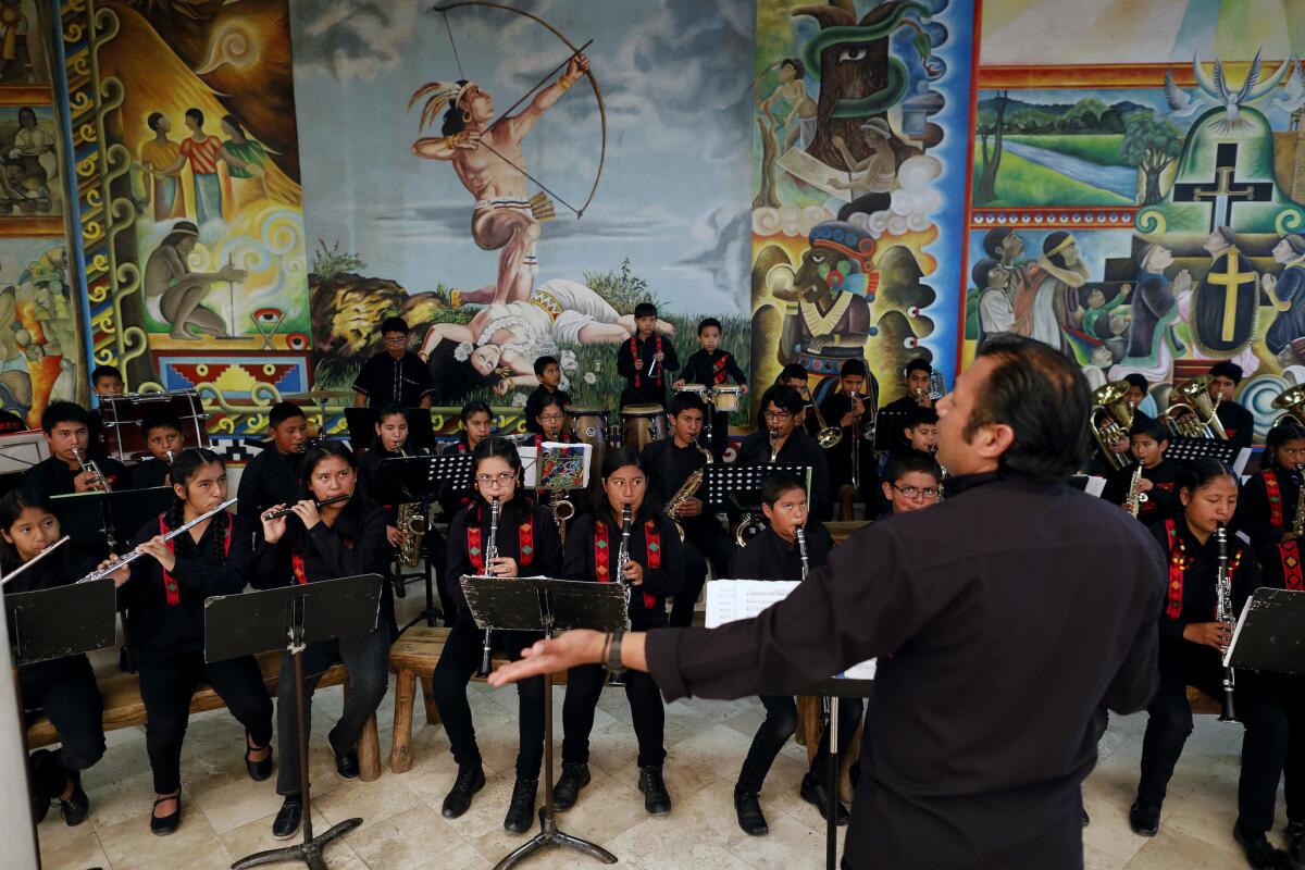 Alejandro Zamora warms up La Banda Sinfónica de Tlaxiaco. (Gary Coronado / Los Angeles Times)