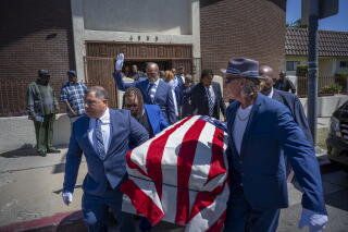 Members move Joe Harris' casket outside of Lewis Metropolitan CNE Church.