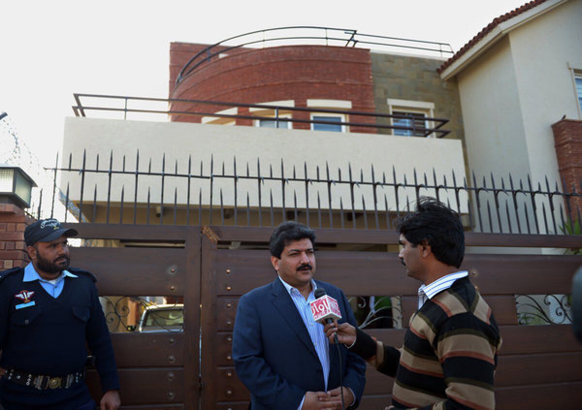 Pakistani journalist and television anchor Hamid Mir talks with media representatives outside his home in Islamabad on Monday.