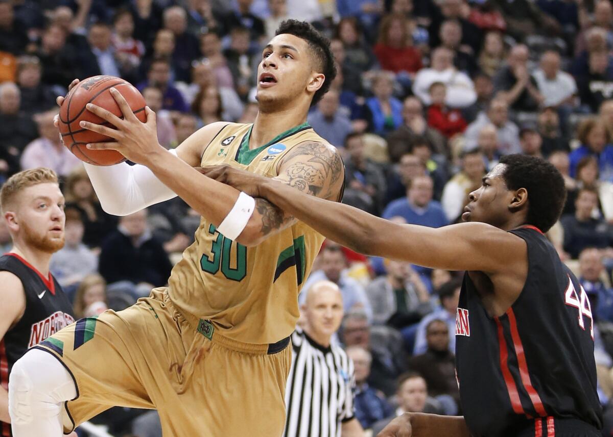 Notre Dame's Zach Auguste drives past Northeastern's Reggie Spencer during the Irish's 69-65 win on Thursday.