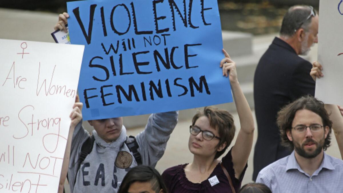 People protest on the Utah State University campus on Wednesday after Anita Sarkeesian canceled her appearance following threats of a mass school shooting. (Rick Bowmer / Associated Press