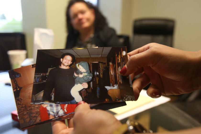 Brittany Glenn looks through pictures of her brother Brendon, who was shot and killed by a Los Angeles police officer last year in Venice, as their mother, Sheri Camprone, looks on. In the photo, Brendon Glenn is holding his son, Avery.