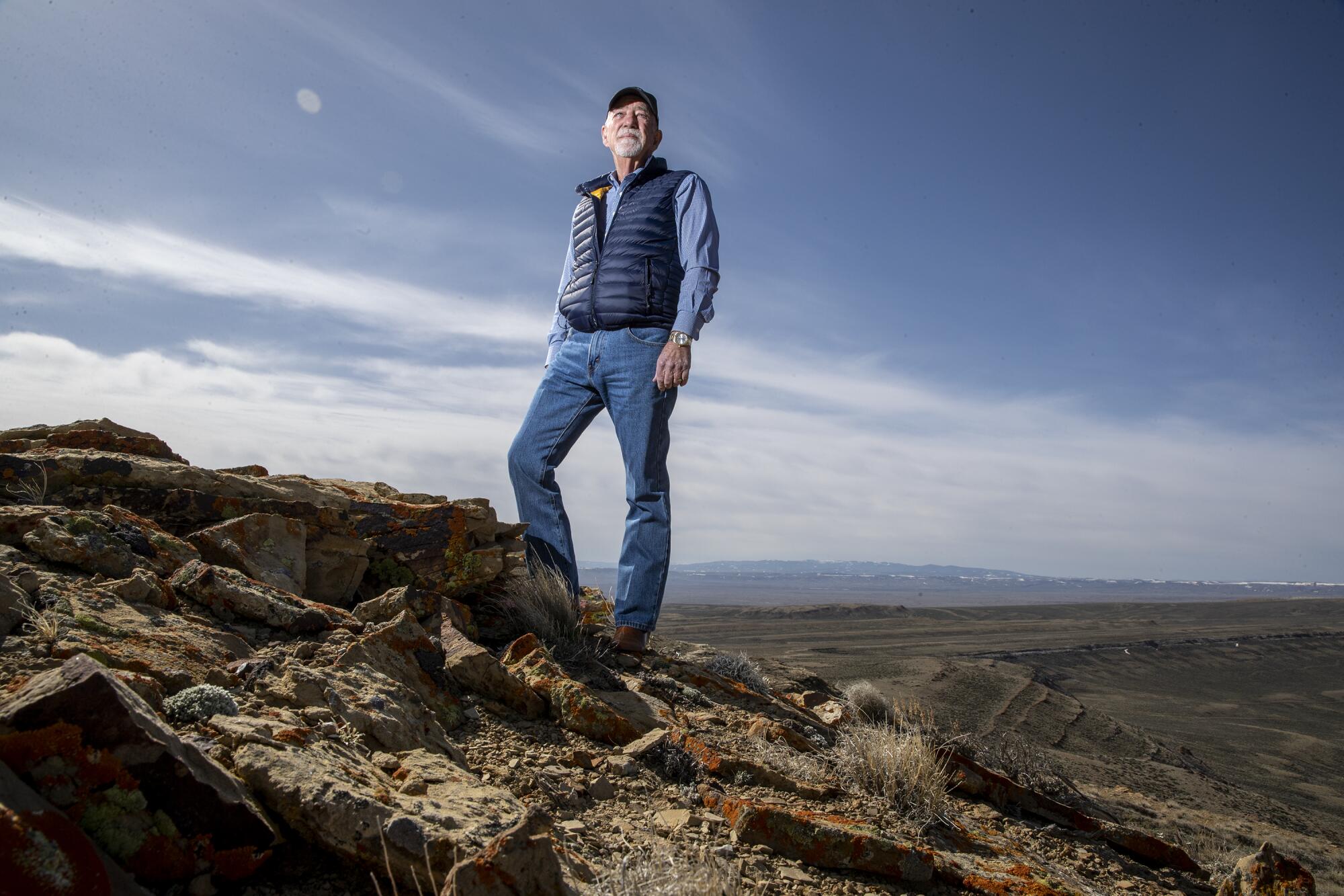 Bill Miller stands on a hill overlooking Overland Trail Ranch.