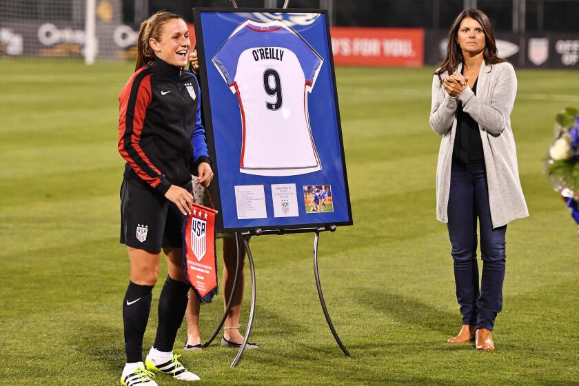 United States' Heather O'Reilly (9) is joined on the field by former player Mia Hamm as O'Reilly is honored before her final international match, against Thailand on Sept. 15.