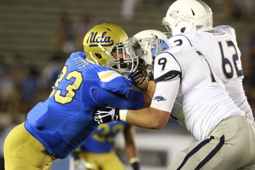 UCLA defensive lineman Kyle Fitts holds his ground against Nevada's Jacob Henry and Zach Brickell during the season-opening victory.