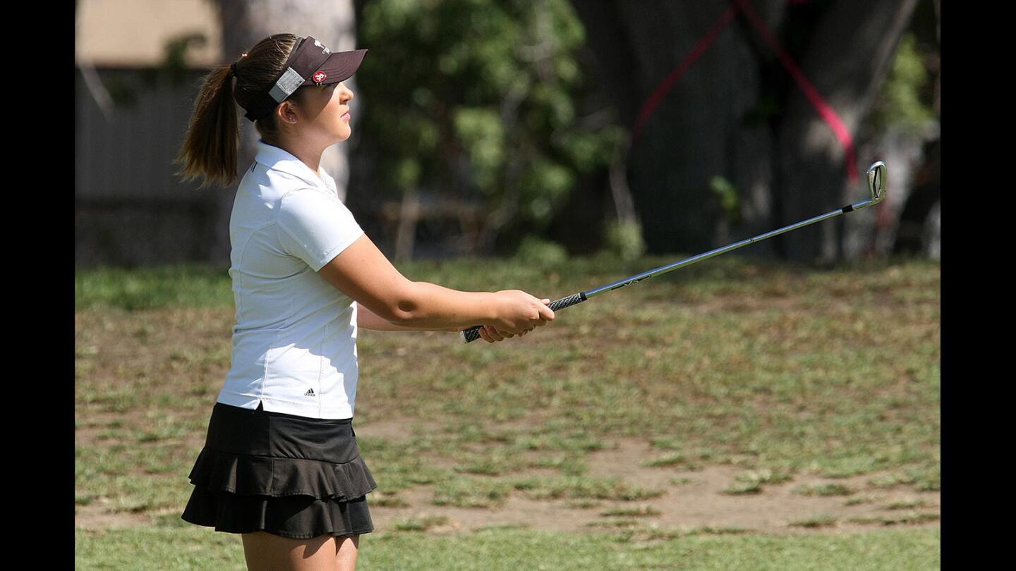 Burroughs' Ashley Phelps watches her ball in flight on the first fairway in a Pacific League girls' golf match at Santa Anita Golf Course in Arcadia on Wednesday, October 5, 2016.