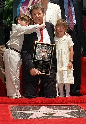 Actor David Nelson poses with his grandson, Michael Woolery, and family friend Ashley Holt as he is honored with the 2,065th star on the Hollywood Walk of Fame on May 9, 1996. Nelson, who starred on his parents' popular television show, "The Adventures of Ozzie and Harriet, " died in Los Angeles on Tuesday. He was 74. See full story
