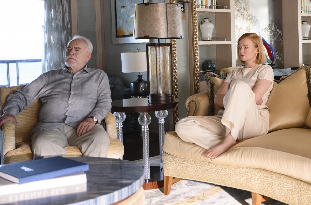 Brian Cox and Sarah Snook watch television in "Succession."
