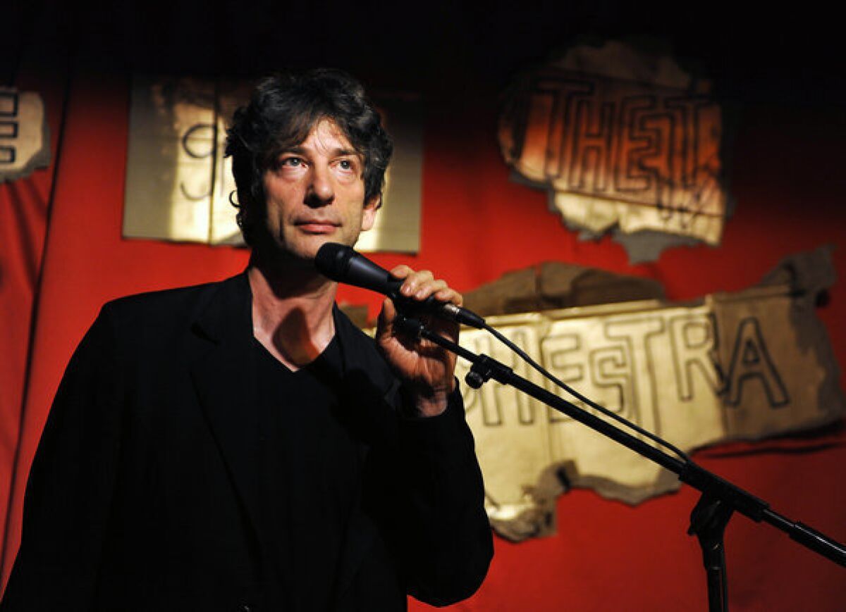 Neil Gaiman on stage as part of a performance by his wife, musician Amanda Palmer.