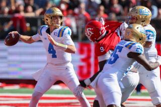 UCLA quarterback Ethan Garbers stays in the pocket and prepares to pass under pressure from Rutgers