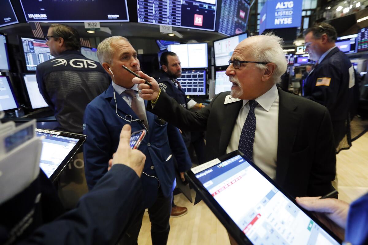 Traders Timothy Nick, left, and Peter Tuchman at the New York Stock Exchange.