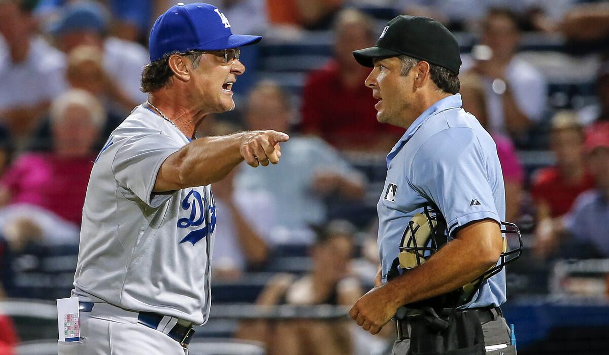 Los Angeles Dodgers manager Don Mattingly argues with home plate umpire James Hoye during the eighth inning against the Alanta Braves on Tuesday.