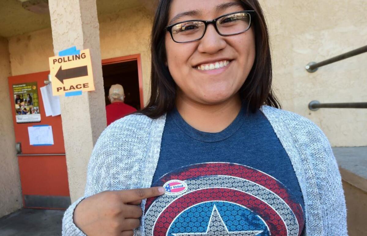 First time voter Sonia Orea points to her sticker after voting in Boyle Heights.