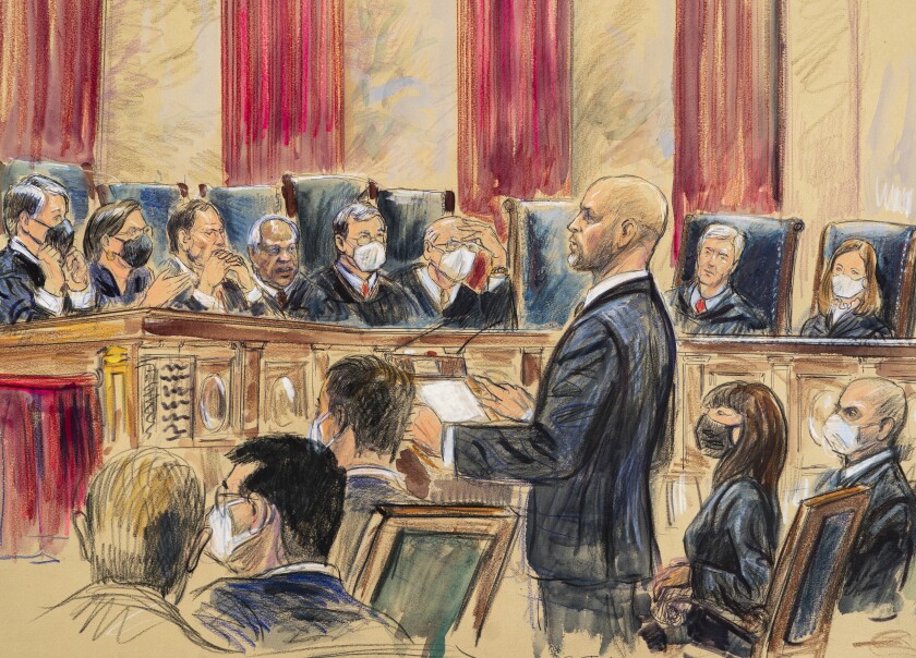 This artist sketch depicts lawyer Scott Keller standing to argue on behalf of more than two dozen business groups seeking an immediate order from the Supreme Court to halt a Biden administration order to impose a vaccine-or-testing requirement on the nation's large employers during the COVID-19 pandemic, at the Supreme Court in Washington, Friday, Jan. 7, 2022. Solicitor General Elizabeth Prelogar, the Biden administration's top Supreme Court lawyer, is seated at right. (Dana Verkouteren via AP)