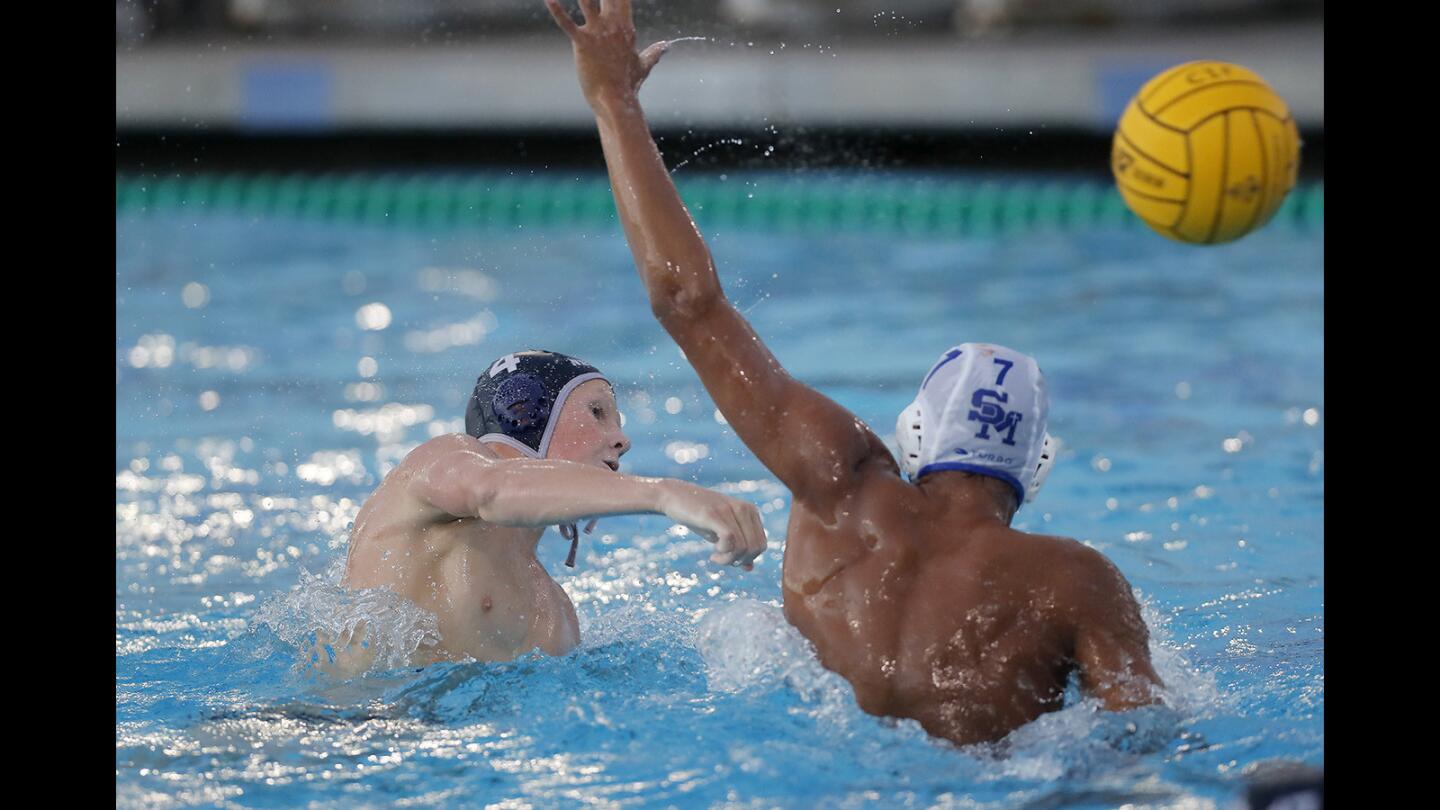 Newport Harbor High's Ryan Brosnan, left, scores the winning goal in the fourth quarter against Santa Margarita's Yurian Quinones in the first round of the CIF Southern Section Division 1 playoffs in Newport Beach on Thursday, Nov. 2. Sailors won 6-5.
