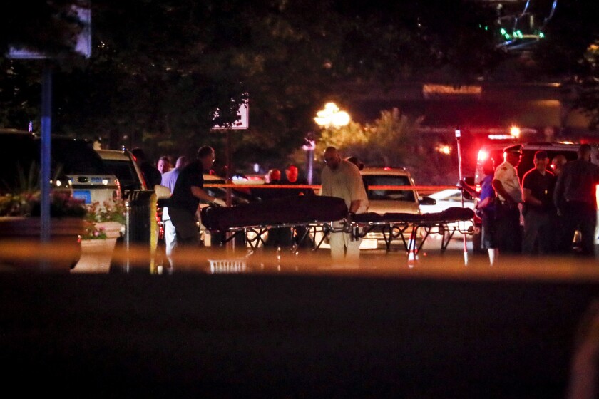 Bodies are removed from the scene of a mass shooting early Sunday in Dayton, Ohio, in which nine people died, the second mass killing in the country in as many days.