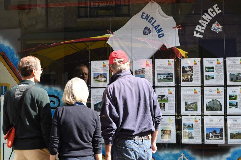 People look at ads at a real estate agency catering to British buyers in Eymet, France, which has a large population of British expatriates.