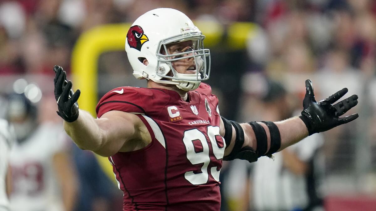 Arizona Cardinals defensive end J.J. Watt raises his arms  during the first half of a game against the Houston Texans.