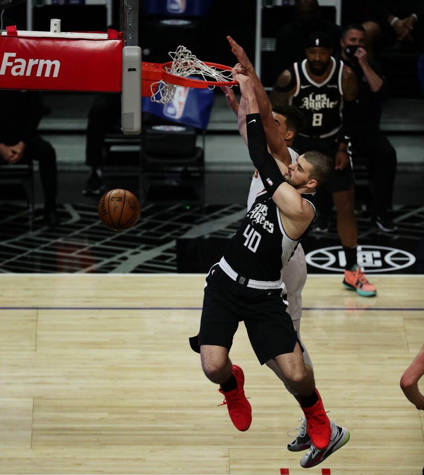 Clippers center Ivica Zubac dunks over Denver Nuggets forward Michael Porter Jr. during the first half Saturday.