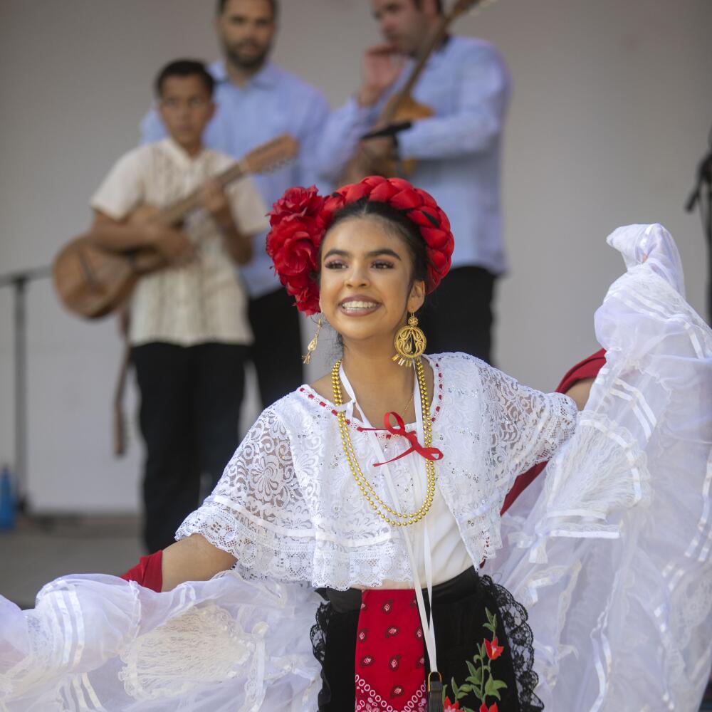 Ayleen Martinez dances on the tarima while Los Hermanos Herrera play onstage.