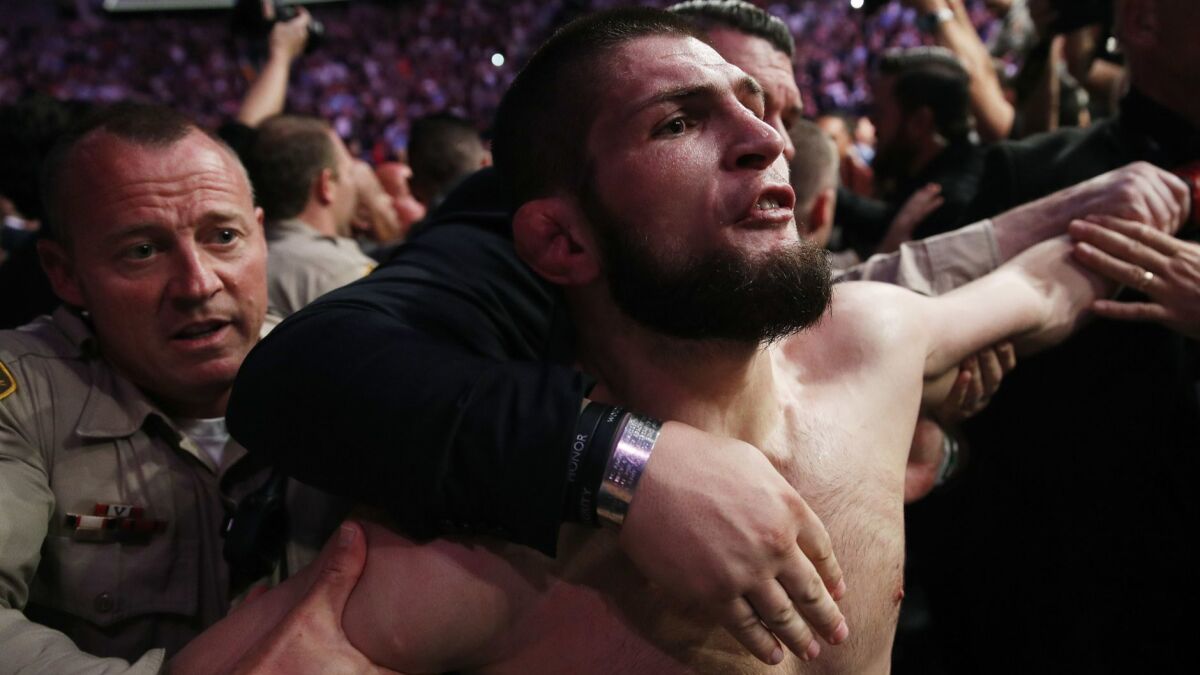 Khabib Nurmagomedov is held back outside of cage after fighting Conor McGregor at UFC 229 on Oct. 6 in Las Vegas.