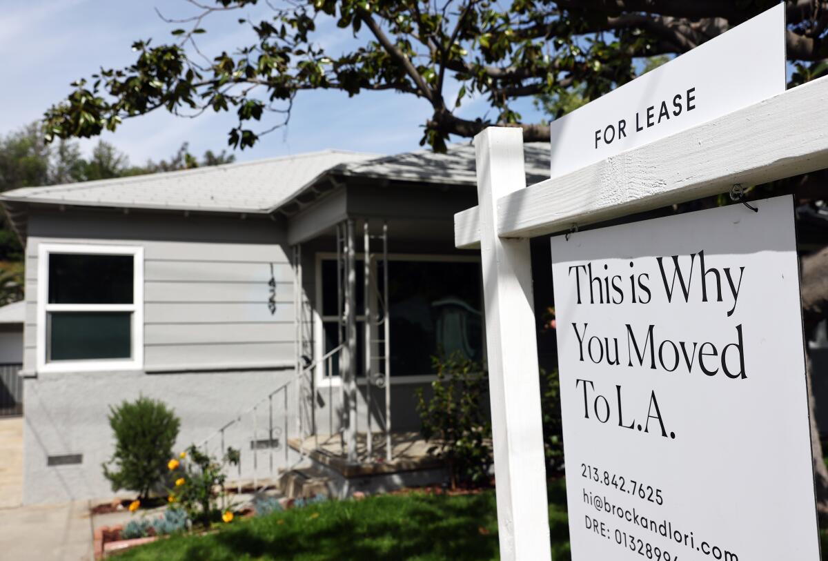A sign in front of a tidy gray house reads "For lease: This is Why You Moved to L.A.," followed by contact information.