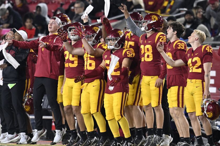 USC players celebrate on the sideline while playing California 