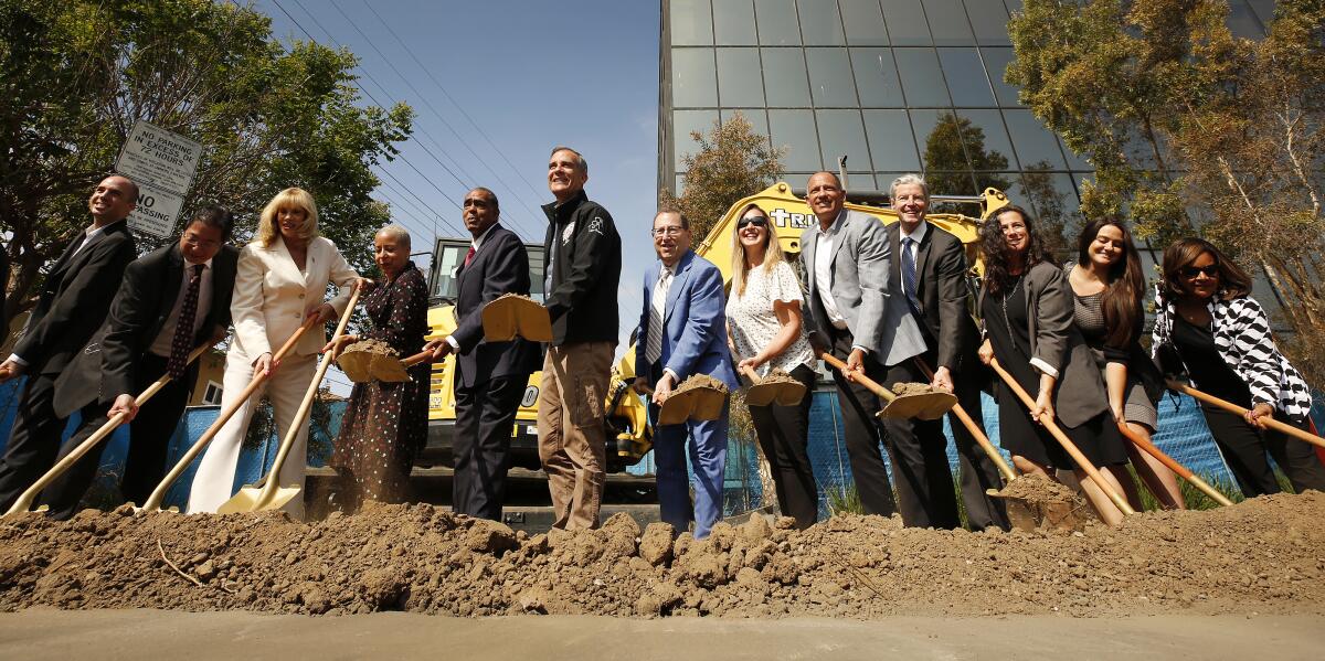 Then-Mayor Eric Garcetti and others hold shovels at a groundbreaking.