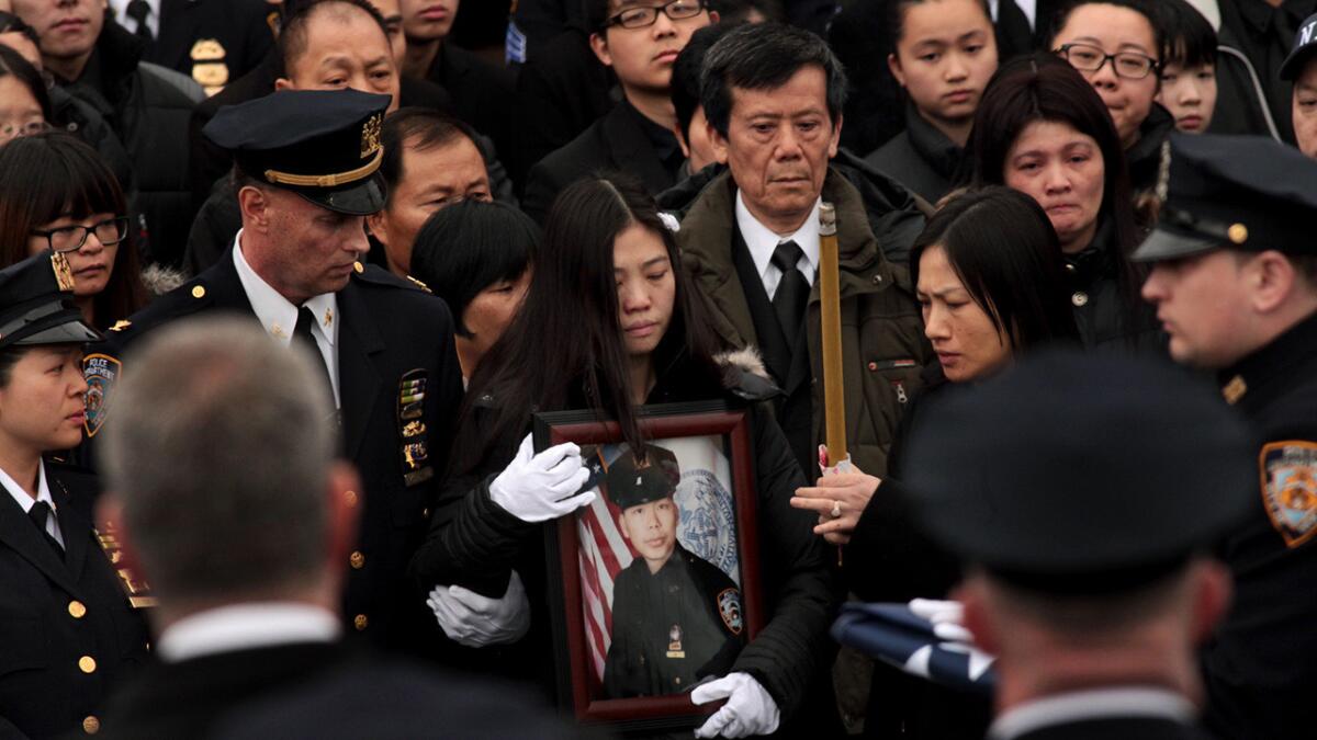Pei Xia Chen, center, widow of NYPD Officer Wenjian Liu, at his funeral in Brooklyn.